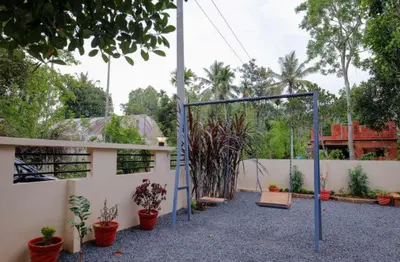 a batting cage in a garden with potted plants at Greenfield Homestay in Vythiri