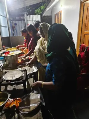 a group of people in a kitchen preparing food at CELESTIAL HOMESTAY in Pinangode