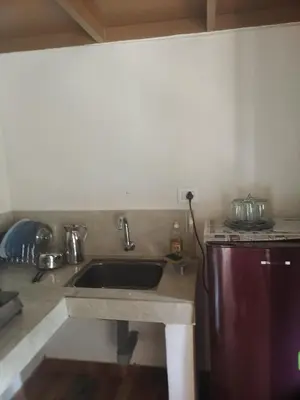 a kitchen with a sink and a counter top at CELESTIAL HOMESTAY in Pinangode