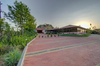 a brick walkway with a building in the background at Woodstock Resorts in Madikeri