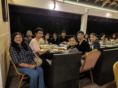 a group of people sitting at a table eating at Vintage Vista in Lakkidi