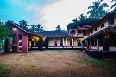a house with a large yard in front of it at Vintage Vista in Lakkidi