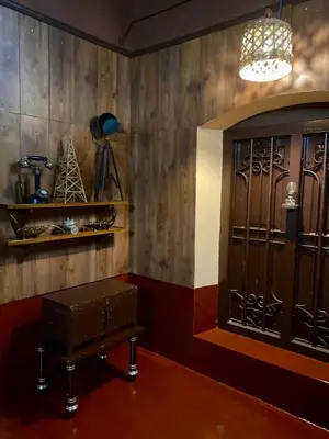 a room with a wooden wall with a large door at Vintage Vista in Lakkidi