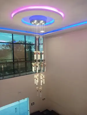a room with a ceiling with a chandelier at ANTARA STAY in Coimbatore