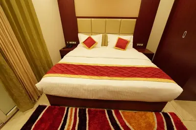 a bedroom with a large bed with two pillows at Hotel Newline Orchid in Guruvāyūr