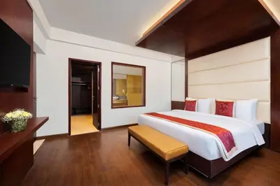 a bedroom with a large bed and a television at Fortune Park, Tiruppur - Member ITC Hotels' Group in Tiruppūr