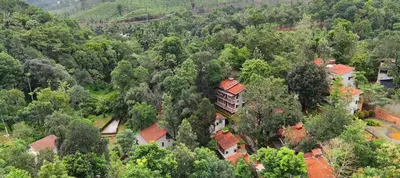 an aerial view of a house in the forest at Safari Hills in Vayittiri