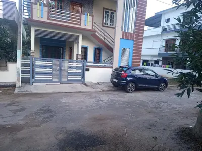 a blue car parked in front of a house at 