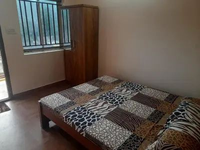 a bed with a quilt on it in a room at Paadi Inn in Kakkabe