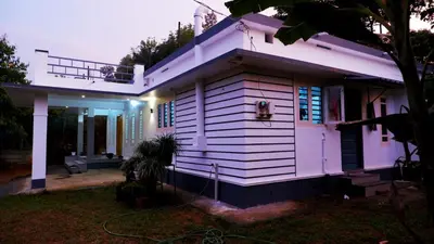 a small white house with a house at WAYANAD OASIS VILLa in Kalpetta