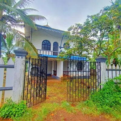 a house with a gate in front of it at Kalpetta Peace Villa in Kalpetta