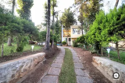 a stone path in front of a house at Coorg Avani Holiday Inn in Madikeri