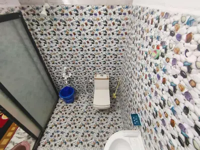 a bathroom with a sink and a tiled wall at Mannat Inn (Peace Homestay) in Mysore