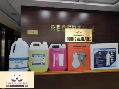 a shelf with several bottles of detergents on it at The Grand Inn Mysore in Mysore