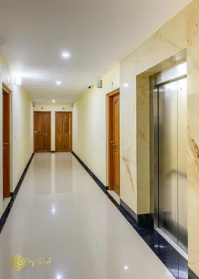 a hallway of a building with a elevator at Daffodils Luxury Airport Suites in Cochin