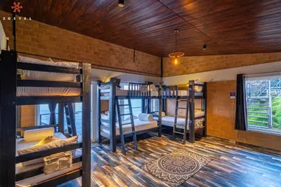 a room with several bunk beds in it at Zostel Plus Poombarai, Kodaikanal in Kodaikānāl