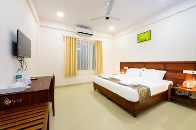 a bedroom with a large bed and a television at Daffodils Luxury Airport Suites in Angamali