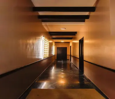 an empty hallway with a long corridor at Hotel Vinayaga Excellenciy Tiruppur in Tiruppūr