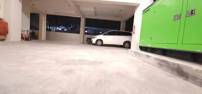 a parking garage with a white car parked in it at ELITE RESIDENCY in Palani