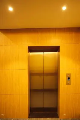a elevator in a building with wooden walls at ELITE RESIDENCY in Palani