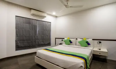 a bedroom with a large bed in a room at Treebo Brahma, Wayanad in Sultan Bathery