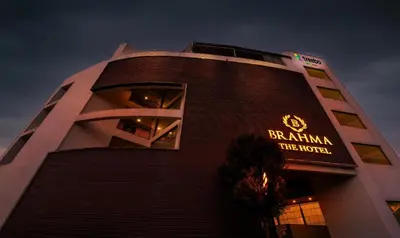a building with a sign on the side of it at Treebo Brahma, Wayanad in Sultan Bathery