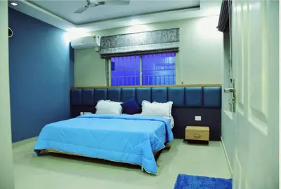 a blue bedroom with a blue bed and a window at Ivory sea castle in Kozhikode