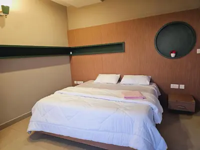 a bedroom with a large bed with a mirror at Ivory sea castle in Kozhikode