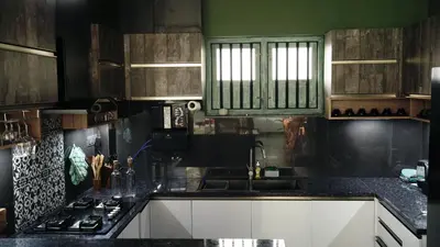 a kitchen with a sink and a stove top oven at Lofterra in Kozhikode