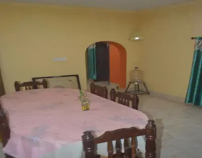 a room with a table with a pink table cloth at Kalpavruksha Farmstay by StayApart in Madikeri