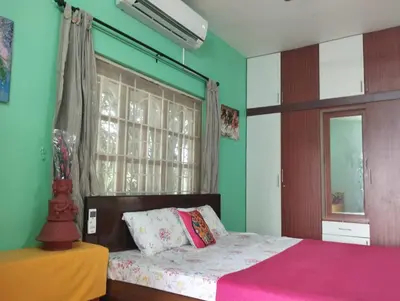 a bedroom with a bed and a window at SHI's Isha Homestay in Coimbatore in Coimbatore