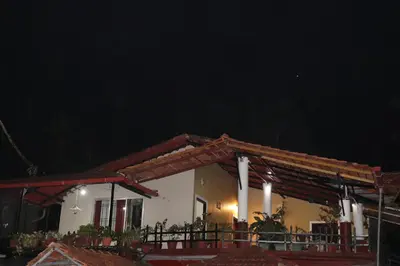 a house at night with a dark sky at Coorg Northbreeze Estate stay in Madikeri