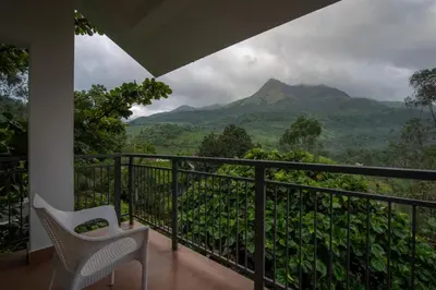 a balcony with a view of a mountain at Dazzle Villa Resort in Kalpetta