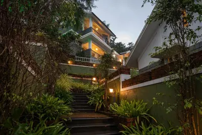 a house with stairs leading up to it at Dazzle Villa Resort in Kalpetta