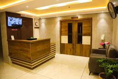 a lobby with a reception desk and a door at Mezkar Residency in Alwaye