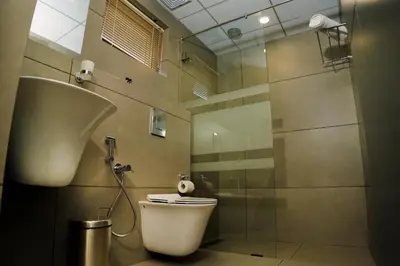 a bathroom with a toilet and a shower at Leaves Resort Vythiri Wayanad in Vythiri
