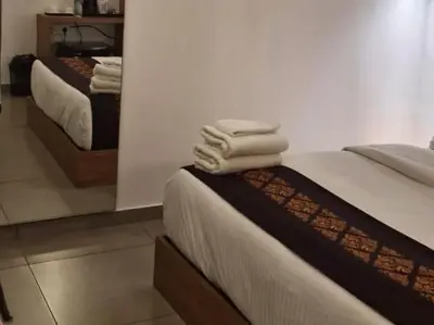two towels stacked on a bed in a room at Leaves Resort Vythiri Wayanad in Vythiri