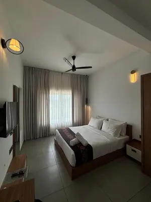 a bedroom with a large bed with a ceiling fan at Leaves Resort Vythiri Wayanad in Vythiri