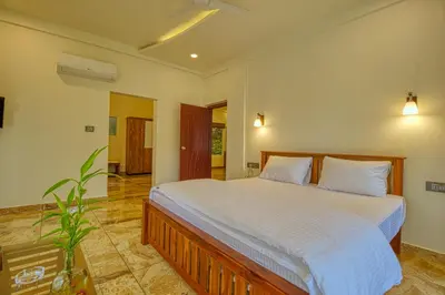 a bedroom with a large bed in a room at Ende Wayanad Resort in Koroth