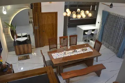a living room with a table and chairs and a piano at Earth - Luxurious 5 BHK AC Villa at Mysore in Mysore
