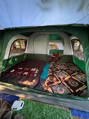 a bed in the inside of a tent at Dragster Tents in Kizhake Chālakudi