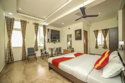 a bedroom with a bed with a ceiling fan at AVJ Nest, Kodaikanal in Kodaikānāl