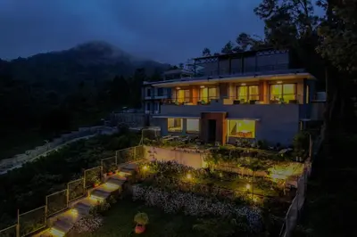 a house with lights in the yard at night at Sri Vidhya Residency by Indo Stays in Kotagiri