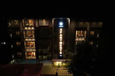 a building with a hotel sign at night at Ncomforts Luxurious Apartments in Perintalmanna