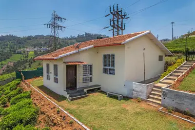 a small white house on top of a hill at The Springs by Indo Stays in Yedapalli
