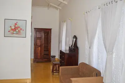 a living room with a couch and a window at Ibex Resorts, Kotagiri in Kotagiri