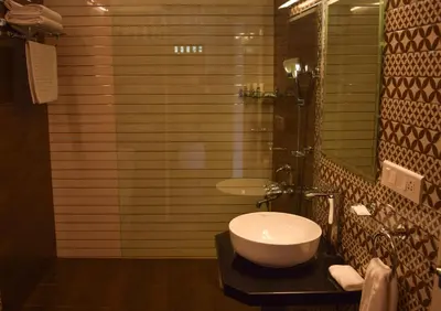 a bathroom with a sink and a toilet and a mirror at Ibex Resorts, Kotagiri in Kotagiri