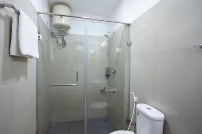 a bathroom with a glass shower with a toilet at StayVista at Little Heaven with Breakfast in Ooty