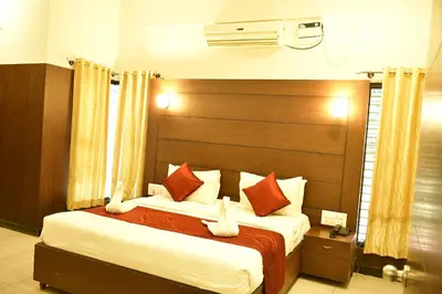 a bedroom with two beds and a large headboard at Nijaguna Resorts in Chāmrājnagar