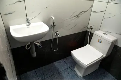 a bathroom with a sink and a toilet at DREAMS VILLA Near Rajagiri Hospital in Alwaye